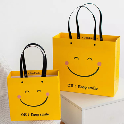 Sacco di carta inferiore di sorriso di iso del fronte di Kraft del quadrato giallo resistente ai colpi dei sacchi di carta